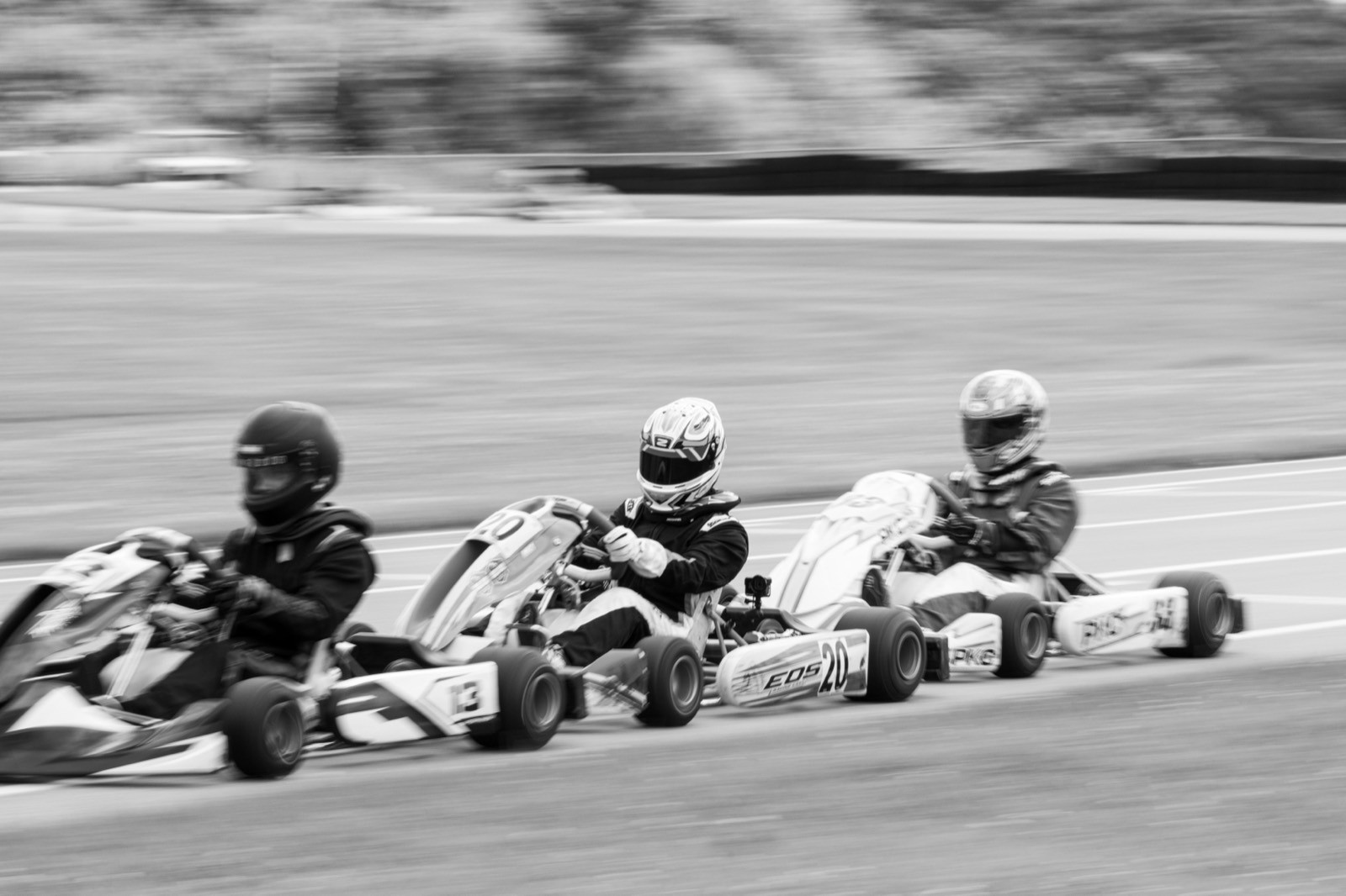 Members karting — three karts racing through a corner